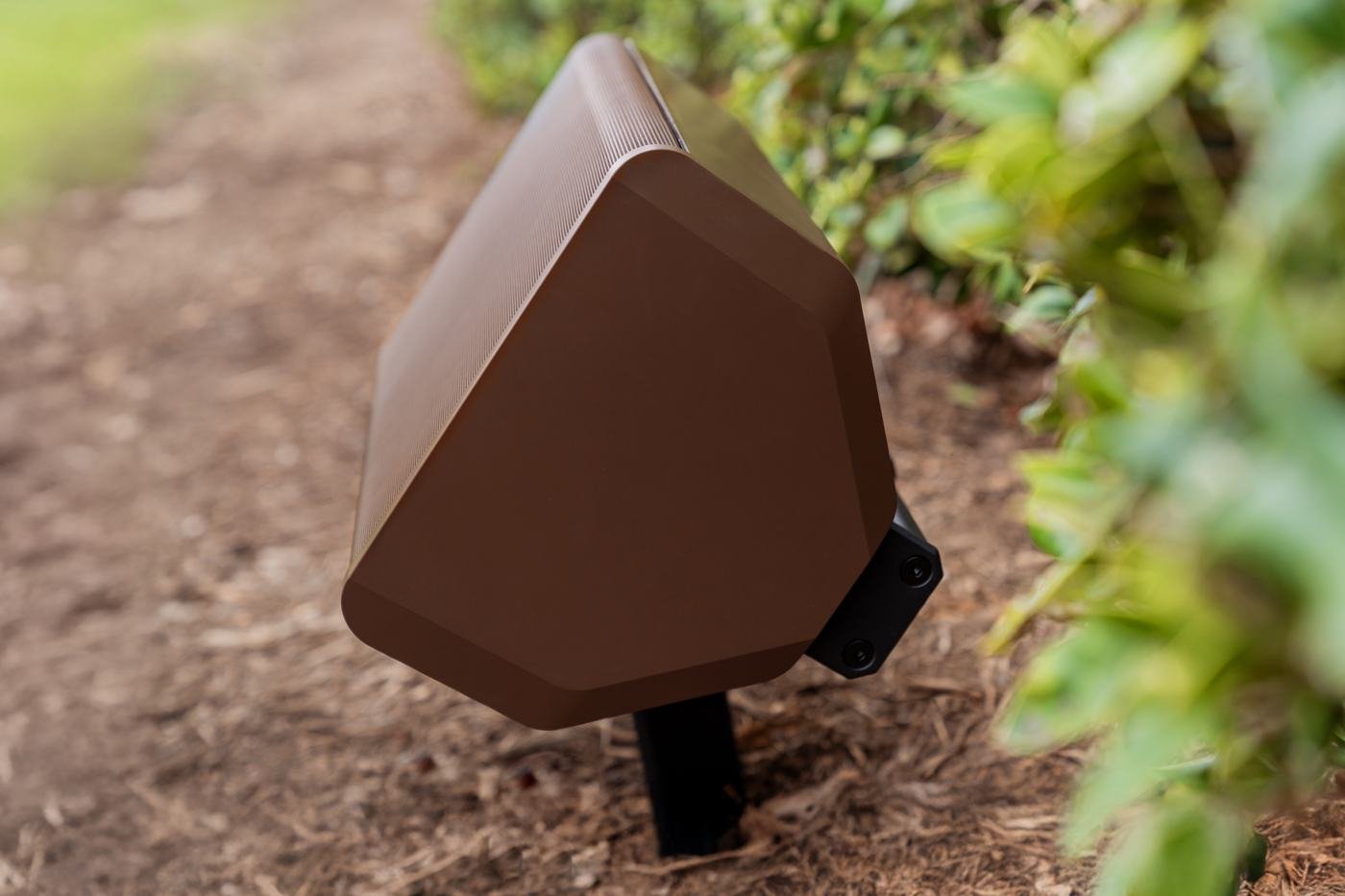 Triad landscape speaker set in a planting bed